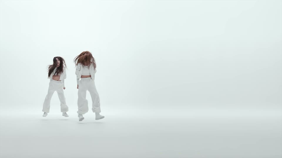 Two dancers moving side by side during the middle of the NEON intro