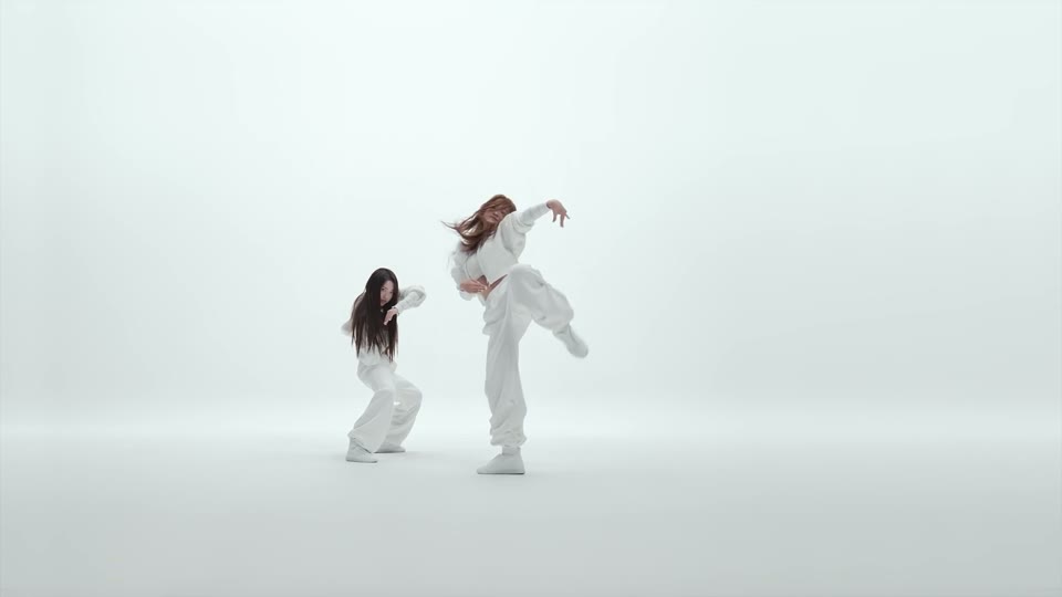 A dancer performing the final leg accent while the partner holds formation